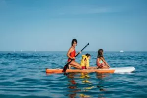Mother with daughters on a sup in croatia
